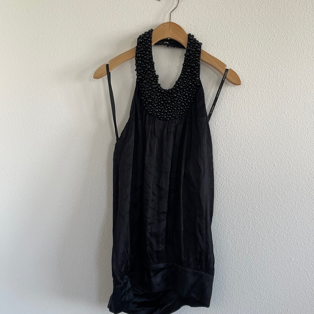 Bebe top 100% silk size XS with gorgeous black beads around the neck.